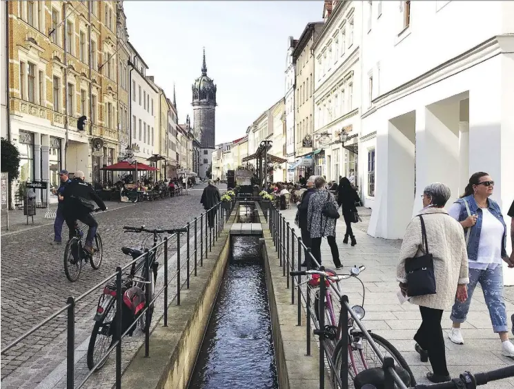  ?? PHOTOS: ELIOT STEIN/FOR THE WASHINGTON POST ?? A canal trickles toward Castle Church, where Martin Luther is said to have nailed his 95 theses to the door.