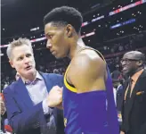  ?? Kevork Djansezian / Getty Images 2017 ?? Warriors coach Steve Kerr talks with guard Patrick McCaw during a game early last season against the Clippers at Staples Center.