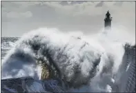  ?? PICTURES: STEVE RIDING/HELEN BROWN/SWNS/OWEN HUMPHREYS/PA ?? A WALK IN THE PARK: Main, the Higgins family enjoy the Easter Monday sun in Roundhay Park, Leeds; left, foam on the seafront in Whitby; right, waves crash against the Tynemouth Lighthouse on the north east coast yesterday.