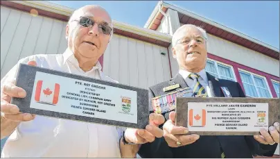  ?? COLIN MACLEAN/JOURNAL PIONEER ?? Roy Crozier, left, and Alan Cameron, right, hold two plaques they plan to lay at the graves of their uncles who died in the Second Word War. Both are buried in the same war cemetery in the U.K. and their nephews have always wanted to visit their graves.