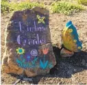  ??  ?? A large stone welcomes visitors to Kimbi’s Garden with hand-lettered artwork, next to a shaded area.