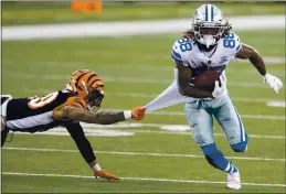  ?? EMILEE CHINN — THE ASSOCIATED PRESS ?? Bengals free safety Jessie Bates (30) grabs Cowboys wide receiver CeeDee Lamb’s (88) jersey in the second half last Sunday in Cincinnati.