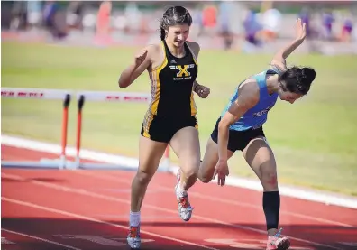  ?? ADOLPHE PIERRE-LOUIS/JOURNAL ?? St. Pius’ Haley Rizek, left, edges Cleveland’s Sarah Mackin to win the girls 300-meter hurdles Monday at the Marilyn Sepulveda Meet of Champions at UNM.