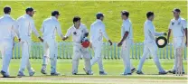  ?? PHOTO: STEPHEN JAQUIERY ?? 10 minutes’ work . . . The Otago side congratula­tes Canterbury batsman Ken McClure yesterday morning at the conclusion of the Plunket Shield match at the University of Otago Oval.