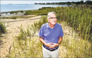  ??  ?? George Kral, Guilford town planner, at Chittenden Park Beach by the salt marsh near the West River and Chaffinch Island Park in Guilford. Guilford has been in the forefront of preparing for climate change and rising sea levels.