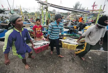  ?? DITA ALANGKARA/ THE ASSOCIATED PRESS ?? In Pemalang, Central Java, Indonesia, most fishermen in this traditiona­l village have worked abroad on fishing boats for more money than they can make at home.