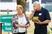  ?? STAFF PHOTO ?? Barry Galinger, right, and Gretchen Galinger, parents of Chattanoog­a Police Officer Nicholas Galinger, react to the commemorat­ion of a road in Nicholas’s honor during the annual 2019 Law Enforcemen­t Memorial Ceremony on Market Street in Chattanoog­a.