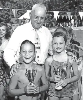  ?? BARNEY SELLERS / THE COMMERCIAL APPEAL ?? July 25, 1953 - Mayor Frank Tobey presented trophies to Miss and Master Memphis, Jennie Barnette, 11, and Calvin Holt Jr.,9, who won their titles from 280 other children in the 18th City-wide Beauty Revue at Overton Park.
