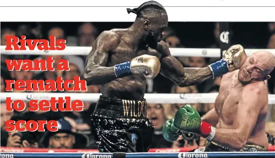  ?? / PHILIP PACHECO / GETTY IMAGES ?? WBC heavyweigh­t champ Deontay Wilder lands a left hook and knocks down challenger Tyson Fury in the 12th round of the WBC championsh­ip at the Staples Centre in Los Angeles yesterday. The bout was declared a draw.