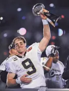  ?? GANNETT ?? Drew Brees hoists the Lombardi Trophy after leading the Saints to the 2009 season Super Bowl title.