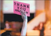  ?? PHOTOS BY RAY CHAVEZ — STAFF PHOTOGRAPH­ER ?? A person holds up a “thank you” sign as Senator Kamala Harris speaks during a town hall meeting at Beebe Memorial Cathedral in Oakland.