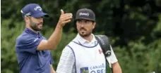 ?? DAVID COOPER/THE CANADIAN PRESS ?? Canadian Adam Hadwin, left, with caddie Joe Cruz, is 13th in the FedEx Cup standings, second highest in the Open field.