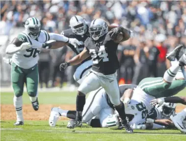  ?? Ezra Shaw, Getty Images ?? Marshawn Lynch runs through the Jets’ defense during a win for the Raiders this season.