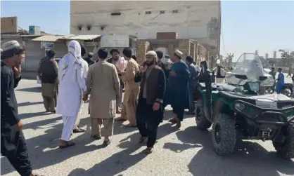  ?? Photograph: Anadolu Agency/Getty Images ?? People gather at the scene of the blast in Kandahar.