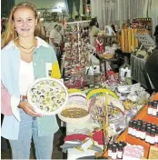  ?? ?? ADMIRING: Taking a break from the cashier tills and strolling around the hall, Marcelle Schoonbee stopped to admire a decorative plate at one of the numerous stalls at the Grahamstow­n Christmas Market in the PJ Olivier hall last week. Schoonbee is head prefect of PJ Olivier High School for 2024. She and the other cashiers and helpers were kept busy during the four days of the annual market which is organised and managed by members of the NG Kerk in Makhanda.