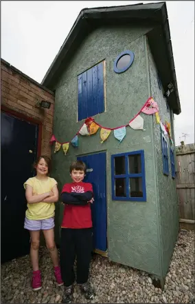  ??  ?? Victory: Emily Clark, eight, and Charlie, six, with their Wendy house