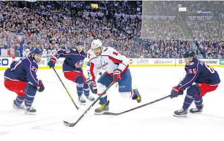  ?? — GETTY IMAGES ?? Alex Ovechkin of the Capitals splits Blue Jackets defenders Ryan Murray, left, and Markus Nutivaara during Game 4 in their Eastern Conference quarter-final Thursday in Columbus.