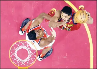  ??  ?? Cleveland Cavaliers’ Tristan Thompson (right), drives to the basket against Washington Wizards’ Thomas Bryantduri­ng the first half of an NBA basketball game on Dec 8 in Cleveland. (AP)