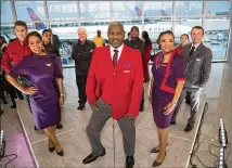  ?? STEVE SCHAEFER / FOR THE AJC ?? Delta employees pose in their new uniforms at the Delta uniform launch in the Internatio­nal Terminal at Hartsfield-Jackson Internatio­nal Airport in May 2018.