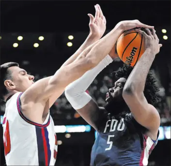  ?? Paul Sancya The Associated Press ?? Center Vladislav Goldin, left, and his Florida Atlantic teammates are among the surprises still alive as the tournament reaches the Sweet 16.