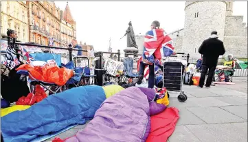  ?? — Reuters photo ?? Royal fans awake at first light having spent the night outside of Windsor Castle, on Friday.