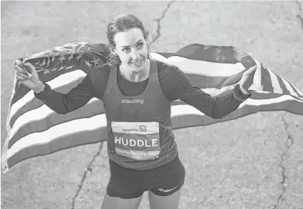  ?? Yi-Chin Lee / Houston Chronicle ?? Old Glory followed new glory after Molly Huddle of Providence, R.I., set an American record in the women’s half-marathon Sunday, finishing the 13.1 miles in Houston’s Aramco-sponsored race in 67 minutes, 25 seconds.