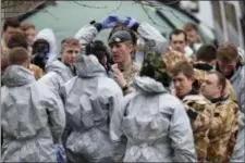  ?? ANDREW MATTHEWS — PA VIA AP ?? Military personnel are prepared before working to remove cars from a car park in Salisbury, England, as police and members of the armed forces probe the suspected nerve agent attack on Russian double agent spy Sergei Skripal, Sunday.