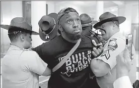  ?? AP/JOHN BAZEMORE ?? Georgia state troopers arrest a man Tuesday in Atlanta’s state Capitol during a protest over election ballot counts.