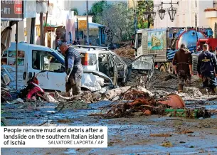  ?? SALVATORE LAPORTA / AP ?? People remove mud and debris after a landslide on the southern Italian island of Ischia