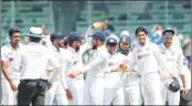  ?? — Pic BCCI ?? Indian players celebrate after R Ashwin takes an English wicket on Day 2 of the second Test match being played at Chepauk Stadium in Chennai on Sunday