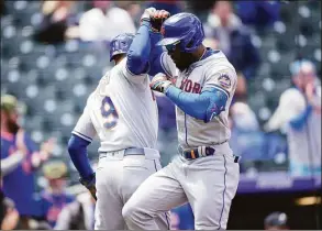  ?? David Zalubowski / Associated Press ?? The Mets’ Starlin Marte, right, celebrates with Brandon Nimmo after hitting a two-run home run in the first inning against the Rockies on Saturday.