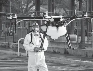  ?? ERIC GAILLARD / REUTERS ?? A disinfecti­on squad uses a drone to spray disinfecta­nt in the streets of the French city of Cannes in the fight against the spread of the coronaviru­s disease on April 10.