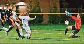  ?? CONTRIBUTE­D BY TINA HUELSMAN ?? Beavercree­k’s Hunter Jackson (left) tries to score against Centervill­e keeper Jonathan Huelsman. The Beavers won the matchup 3-1.