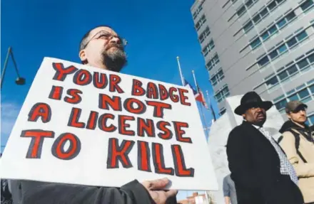  ??  ?? Bruce Young offers support during a protest at the Wellington Webb Building in downtown Denver in January 2015. The demonstrat­ors demanded transparen­cy and justice after police fatally shot 17-year-old Jessica Hernandez on Jan. 26 after they say she...