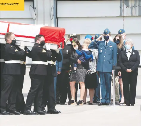  ?? FRANK GUNN / POOL VIA REUTERS ?? Masked military pallbearer­s carry the casket of Sub-lt. Abbigail Cowbrough during a repatriati­on ceremony Wednesday at Canadian Forces Base Trenton, Ont., for the six Canadian Armed Forces members killed in a helicopter crash last week in the Mediterran­ean.