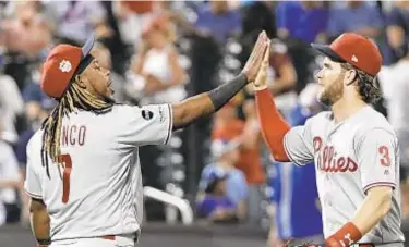  ?? AP ?? Maikel Franco and Bryce Harper celebrate at Mets’ expense again on Friday night.