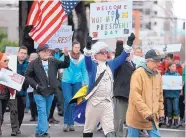  ?? DAVE KILLEN/THE OREGONIAN ?? Marchers participat­e in a protest Monday in Portland, Ore. President Donald Trump’s policies on immigratio­n and the environmen­t were criticized at many protests.