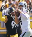  ?? Keith Srakocic Associated Press ?? T.J. WATT hunts Raiders quarterbac­k Derek Carr before suffering an injury.