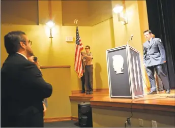  ?? Ben Lambert / Hearst Connecticu­t Media ?? Lewis S. Mills High School students honored local veterans with a luncheon and assembly in honor of Veterans Day. Above, a guest approaches the podium during the assembly.