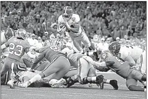  ?? AP/BUTCH DILL ?? Alabama running back Damien Harris (center) dives over the pile for a first down in the second half of the Sugar Bowl against Clemson on Monday in New Orleans. Harris has 983 yards and 11 touchdowns while averaging 7.6 yards per carry.