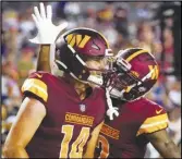  ?? Associated Press ?? Commanders quarterbac­k Sam Howell (left) and wide receiver Dyami Brown celebrate after connecting for a touchdown in an NFL preseason game against the Baltimore Ravens, Monday, in Landover, Md.