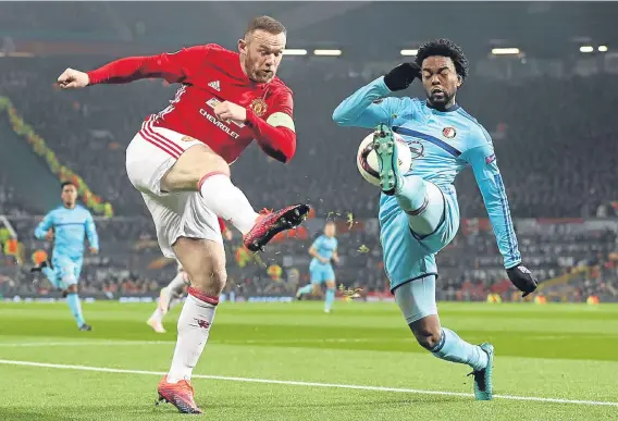  ??  ?? Wayne Rooney (left) and Feyenoord’s Miquel Nelom battle for the ball during Manchester United’s emphatic Old Trafford success.