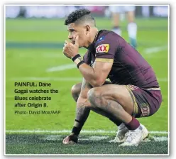  ??  ?? PAINFUL: Dane Gagai watches the Blues celebrate after Origin II.