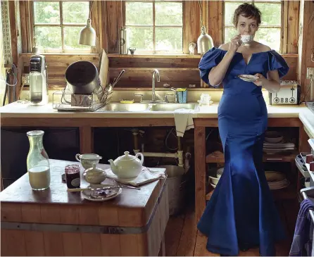  ??  ?? Olivia Colman stars on the cover of US Vogue, below, and raises a laugh, left, in this black and white Annie Leibovitz shot. Right, she has a cuppa in a Zac Posen royal blue dress