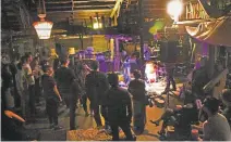  ?? COURTESY OF MAURICE SEATY ?? Partygoers listen to a band playing on the second floor of the Ghost Ship warehouse at a 2014 party, two years before a fatal fire there.