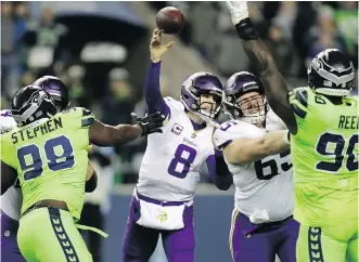  ?? STEPHEN BRASHEAR/THE ASSOCIATED PRESS ?? Vikings quarterbac­k Kirk Cousins delivers a pass while under pressure from onrushing Seahawks defenders during Monday night’s contest in Seattle. The Seahawks won 21-7.