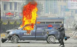  ?? AP ?? ▪ A police officer aims his gun towards protesters during a clash in Islamabad on Saturday.