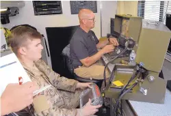  ??  ?? An airman at Kirtland Air Force Base and a Farmington police officer work together to operate two robots during a robot competitio­n. Ten bomb squads from five states are competing this week in the four-day “robot rodeo.”