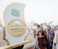 ?? — Reuters ?? Sikhs from India look at the inaugural foundation plaque near the shrine of Guru Nanak Dev Ji during the groundbrea­king ceremony of the Kartarpur Corridor, which will officially open next year, in Kartarpur on Wednesday.