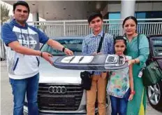  ?? Pankaj Sharma/Gulf News ?? Winner of Audi A3 Hemal Josipura (left), with son Kashish, daughter Viha and wife Shilpa, receives his new vehicle at the Gulf News office in Dubai yesterday.